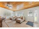 Bright living room with a wooden ceiling, neutral-toned sofa, and lots of natural light at 2918 8Th W Ave, Bradenton, FL 34205