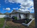 View of the backyard with new fencing and well-kept landscaping at 3507 65Th Avenue E Cir, Sarasota, FL 34243