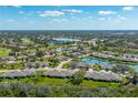 Stunning aerial view of a golf course community with ponds, mature landscaping, and well-maintained homes at 3641 Gleneagle Dr # 12D, Sarasota, FL 34238