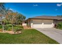 Charming home with a two-car garage, lush lawn, and meticulously arranged landscaping at 3641 Gleneagle Dr # 12D, Sarasota, FL 34238