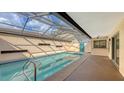 Inviting enclosed pool with clear water, surrounded by a bright patio and a view of the home's exterior at 3692 Glen Oaks Manor Dr, Sarasota, FL 34232