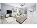 Bright living room featuring a modern ceiling fan, window, neutral décor, and tiled flooring at 3831 Day Bridge Pl, Ellenton, FL 34222