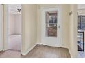 Bright foyer featuring durable vinyl floors and a storm door with glass at 4414 Spicewood Dr # H, Bradenton, FL 34208