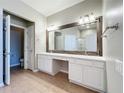 Spacious bathroom with a large mirror, double vanity, white cabinets and tile flooring at 4744 105Th E Ave, Parrish, FL 34219