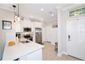Bright kitchen with white cabinetry, stainless steel appliances, and a quartz countertop at 5118 78Th St E Cir, Bradenton, FL 34203