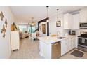 Open-concept kitchen featuring modern appliances and flowing seamlessly into the dining and living areas at 5118 78Th St E Cir, Bradenton, FL 34203
