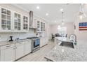 Kitchen with stainless steel appliances, granite countertops, and stylish cabinetry at 5119 Admiral Pointe Dr, Apollo Beach, FL 33572