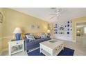 Bright living room with blue accents, built-in shelving, and tile flooring; a cozy and inviting space at 5525 Shadow Lawn Dr, Sarasota, FL 34242