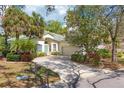 Beautiful single-Gathering home with a well-maintained lawn, mature trees, and a charming two-car garage at 5655 Downham Mdws, Sarasota, FL 34235