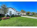 Bright and well-maintained home with a manicured lawn and beautiful landscaping in a suburban neighborhood at 6378 Grandview Hill Ct, Bradenton, FL 34203
