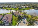 An aerial view of a lakeside property showcasing the home's layout and surrounding landscape at 7108 Callander Cv, Lakewood Ranch, FL 34202