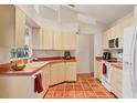 Kitchen featuring tiled floor, a window over sink and bright cabinets at 7821 Geneva Ln # 11, Sarasota, FL 34243