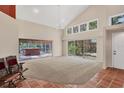 Bright living room with high ceilings, tiled floors, and sliding doors to the outdoor area at 7821 Geneva Ln # 11, Sarasota, FL 34243