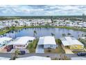 Aerial shot of home with carport with community and lake views providing serene backdrop at 970 Jolanda Cir, Venice, FL 34285