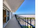 Gorgeous balcony overlooking the beach and the ocean with black metal railing at 101 Benjamin Franklin Dr # 71, Sarasota, FL 34236
