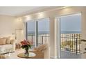 Bright living room showcasing balcony access with beautiful beach views and comfortable, neutral decor at 101 Benjamin Franklin Dr # 71, Sarasota, FL 34236