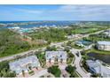 Breathtaking aerial view of the community showcasing water views, tennis courts and perfectly manicured grounds at 10600 Lemon Creek Loop # 102, Englewood, FL 34224