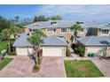 Townhome with brick driveways, attached garages, beautiful landscaping, and neutral-colored exterior at 10600 Lemon Creek Loop # 102, Englewood, FL 34224
