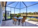Enclosed patio with a dining table set perfect for outdoor gatherings with a serene water view at 11031 Hyacinth Pl, Lakewood Ranch, FL 34202