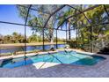 Sparkling swimming pool inside screened enclosure overlooking lush greenery and pond at 11031 Hyacinth Pl, Lakewood Ranch, FL 34202