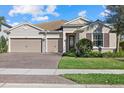 Charming single Gathering home featuring a three-car garage, well-manicured lawn and tasteful landscaping at 12423 Blue Hill Trl, Lakewood Ranch, FL 34211