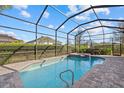 Refreshing pool and hot tub with screened enclosure and beautiful backyard views at 12423 Blue Hill Trl, Lakewood Ranch, FL 34211