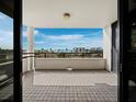 Expansive tiled balcony with a picturesque waterfront view at 1255 N Gulfstream Ave # 407, Sarasota, FL 34236
