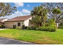 Charming single-story home with well-manicured lawn and tropical landscaping at 3746 Glen Oaks Manor Dr, Sarasota, FL 34232