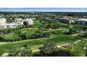 An aerial view of the community golf course showing the well manicured green with water features at 3860 Ironwood Ln # 503G, Bradenton, FL 34209