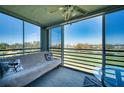 Sunroom/lanai with scenic golf course views from large sliding windows and cozy seating at 4440 Fairways Blvd # 407, Bradenton, FL 34209