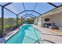 Screened-in pool area features a refreshing pool, comfortable seating, and a mounted television at 4516 Renwick Dr, Parrish, FL 34219