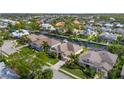 Aerial view of waterfront community showcases homes with canals, docks, and lush landscaping at 4616 Blue Marlin Dr, Bradenton, FL 34208
