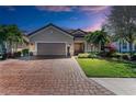 Charming home with a brick paved driveway, two-car garage, and beautiful landscaping at 4632 Benito Ct, Lakewood Ranch, FL 34211