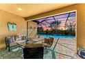 Covered patio features comfortable seating and a view of the pool and golf course at 4632 Benito Ct, Lakewood Ranch, FL 34211