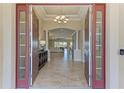 Grand foyer with double doors that opens to living space with tile floors, columns and recessed lighting at 4632 Benito Ct, Lakewood Ranch, FL 34211