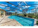 Beautiful screened-in pool with brick surround and view of the golf course, perfect for outdoor entertaining at 4632 Benito Ct, Lakewood Ranch, FL 34211