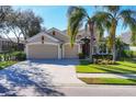 Charming single-Gathering home showcases a well-kept lawn, palm trees, and a convenient three-car garage at 4724 Tilden Park Ct, Bradenton, FL 34211