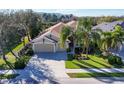 Inviting single-Gathering home boasts mature palm trees, a neatly maintained lawn, and a spacious three-car garage at 4724 Tilden Park Ct, Bradenton, FL 34211