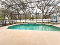 Inviting screened-in pool area with a waterfall feature and ample space for outdoor relaxation and entertaining at 4839 Turtle Bay Ter, Bradenton, FL 34203