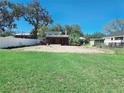 Expansive backyard featuring lush green grass, a privacy fence, and a screened-in patio area at 611 19Th W Ave, Palmetto, FL 34221