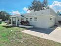 Charming single-story home with a light-colored exterior, covered porch, and well-maintained landscaping at 611 19Th W Ave, Palmetto, FL 34221