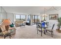 Bright living and dining area features neutral carpet and sliders to the lanai with water views at 6158 Palma Del Mar S Blvd # 504, St Petersburg, FL 33715