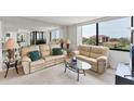Cozy living room with comfortable seating and a serene view from the large window at 6158 Palma Del Mar S Blvd # 504, St Petersburg, FL 33715