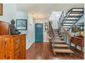 Bright foyer with a staircase and a vibrant blue door adding a pop of color at 7892 S Leewynn Pl, Sarasota, FL 34240