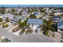 Stunning aerial view of a coastal home featuring lush landscaping and a metal roof at 9 Palm Harbor Dr, Holmes Beach, FL 34217