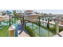 Private boat dock with boat lift showcasing waterfront living and recreational opportunities at 903 Pinellas Bayway S # 102, St Petersburg, FL 33715