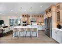 Modern kitchen with stainless steel appliances, ample counter space, and stylish pendant lighting over the island at 9998 Key Haven Rd, Seminole, FL 33777