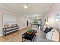 Comfortable living room featuring a large painting, modern furniture, and view to dining area at 1604 Edna Ave, Largo, FL 33770