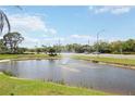 Scenic view of a pond with a fountain and traffic passing by in the distance at 2832 74Th W St # 2180, Bradenton, FL 34209