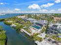 Aerial view of the home's pool and canal with direct gulf access, surrounded by lush landscaping at 3421 Bayou Sound, Longboat Key, FL 34228